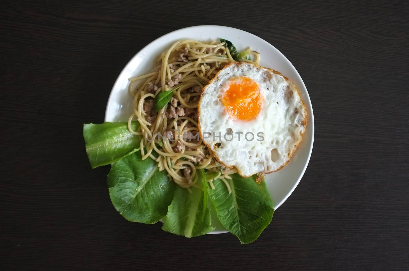 Spaghetti stir fried with Thai Basil spicy sauce with Fried egg  , fusion Thai style