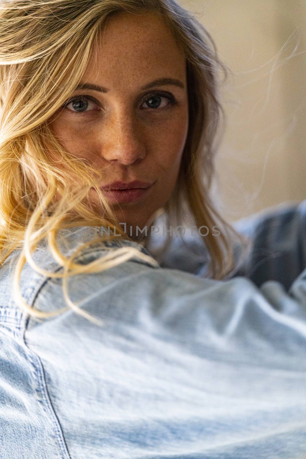 A gorgeous blonde model poses in a parking deck on an autumn day