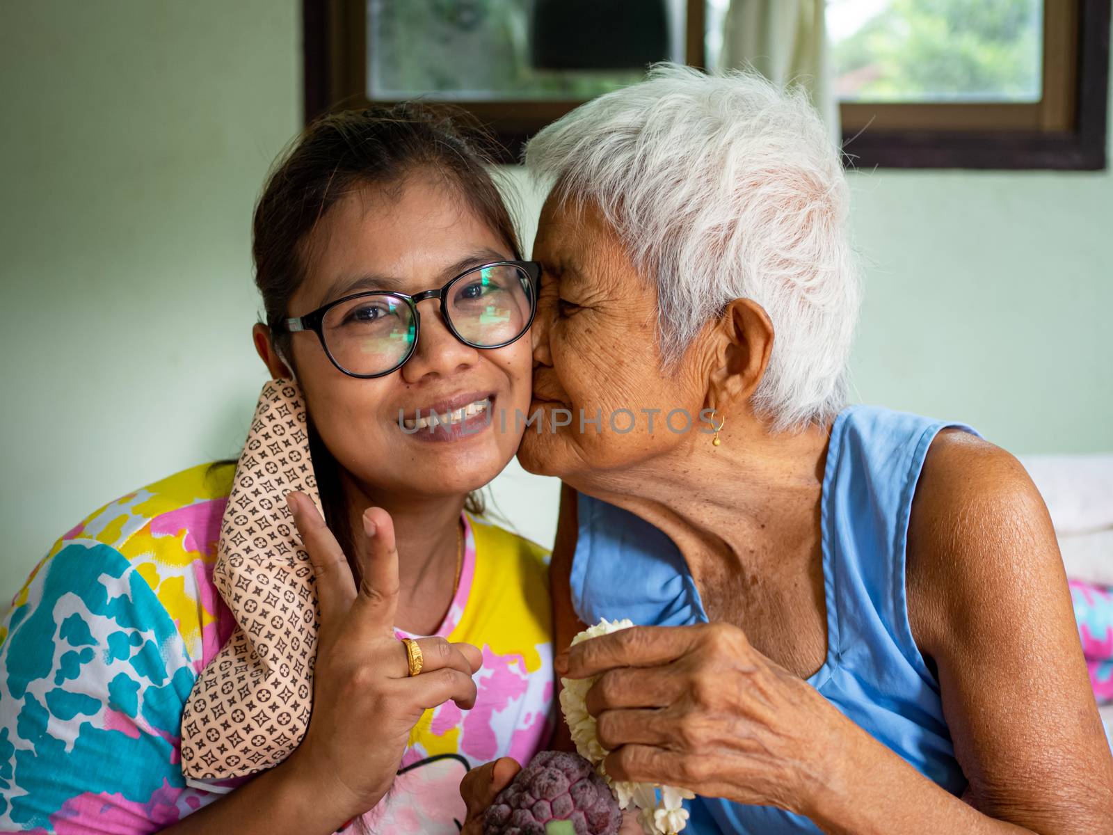 The image of the old woman on the cheek grandchild. real bodies concept.