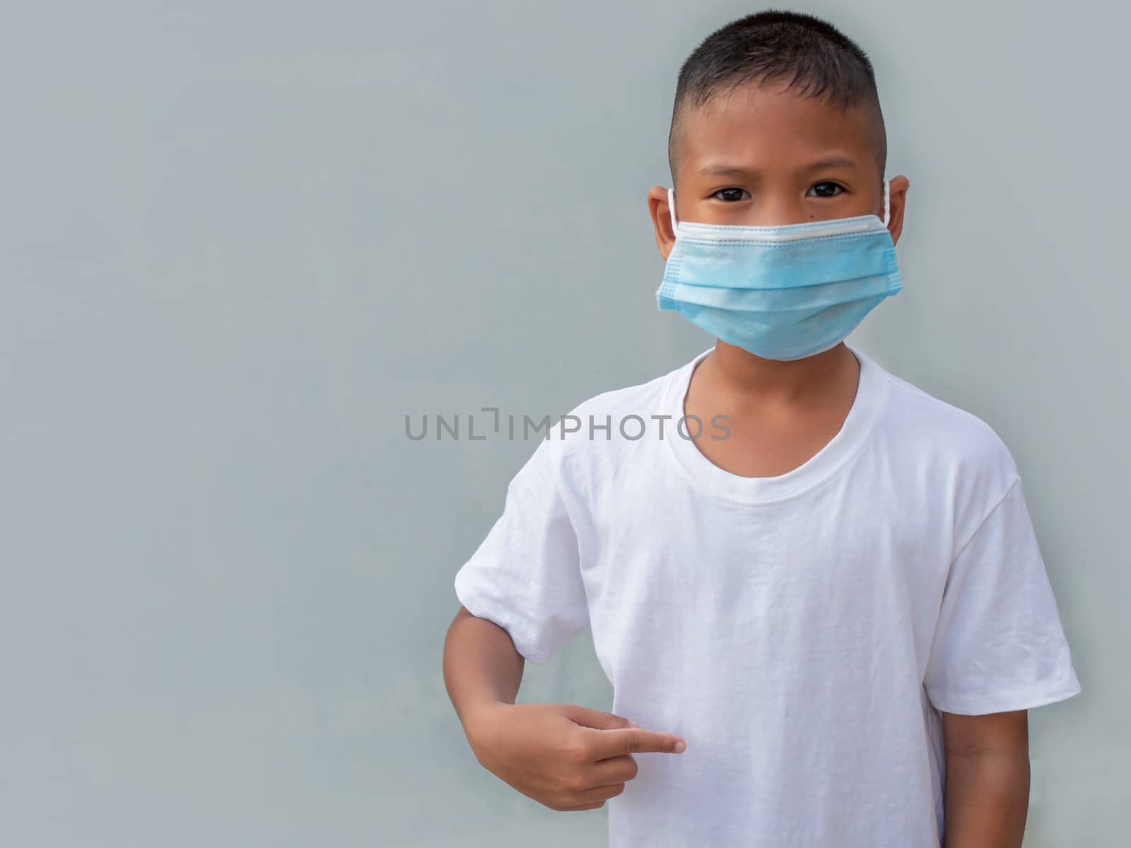 Boy wearing a protective mask On a white background. New normal concept. by Unimages2527