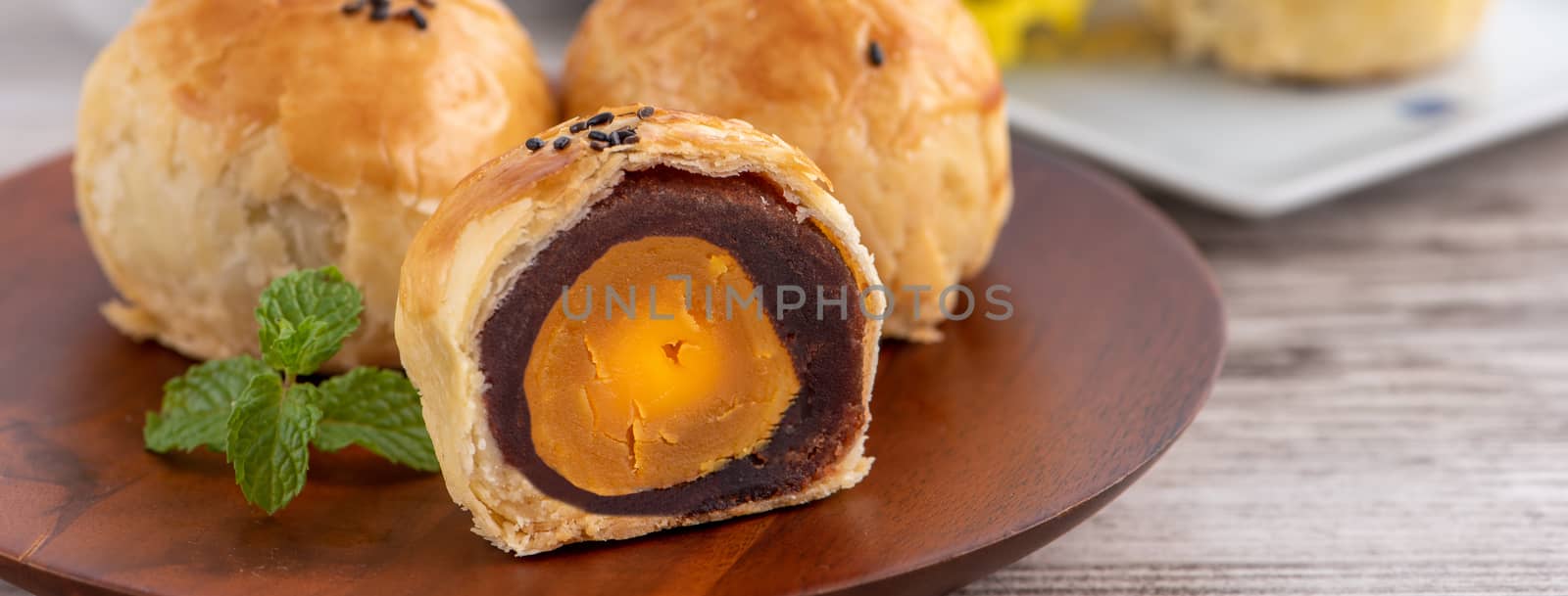 Moon cake yolk pastry, mooncake for Mid-Autumn Festival holiday, top view design concept on bright wooden table with copy space