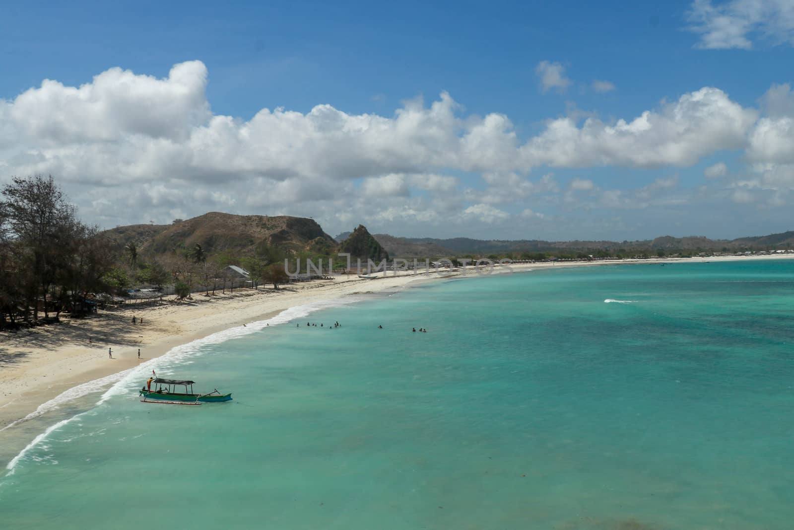 Aerial shot of Tanjung Aan Beach in Lombok, West Nusa Tenggara. Top tourist destination in Indonesia. Huge closed bay with turquoise water.