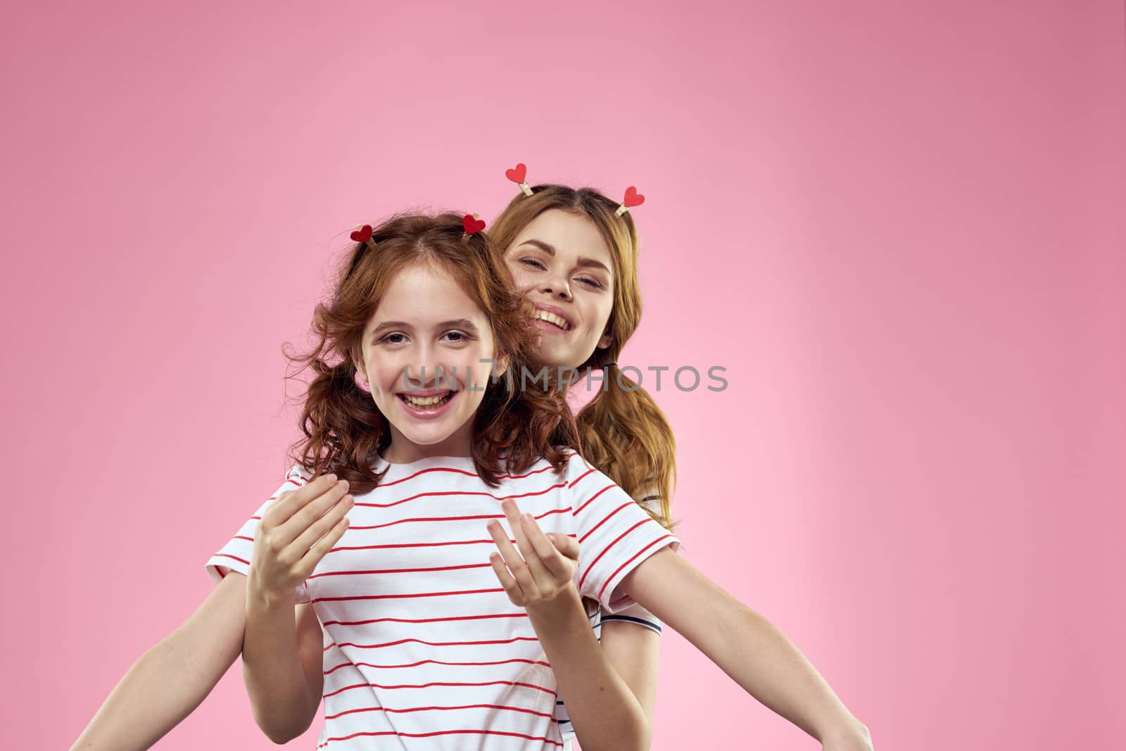 Cheerful mom and daughter joy lifestyle studio pink background family by SHOTPRIME