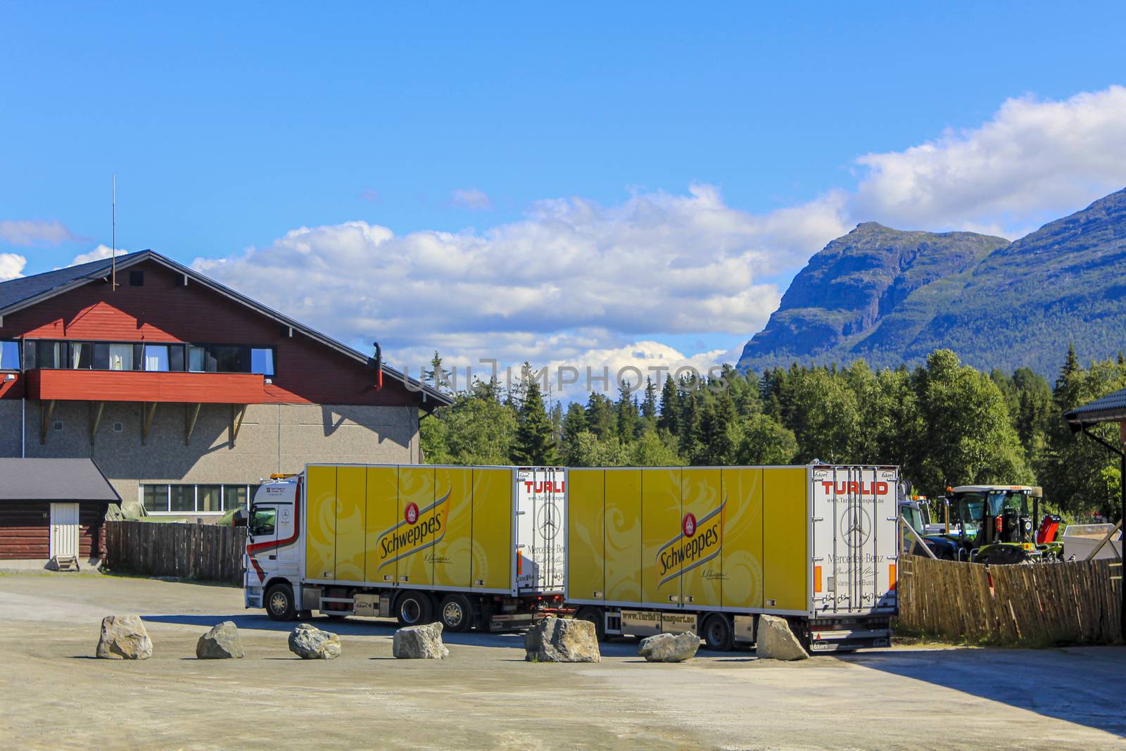 Truck with yellow Schweppes trailer delivers goods to in Hemsedal, Viken, Norway.