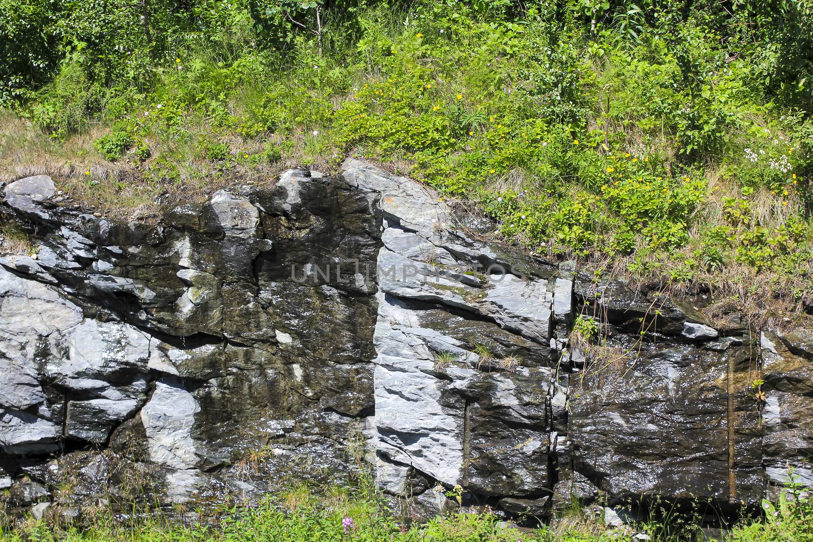 Wet rocks from the rain melt water in Hemsedal, Viken, Norway.