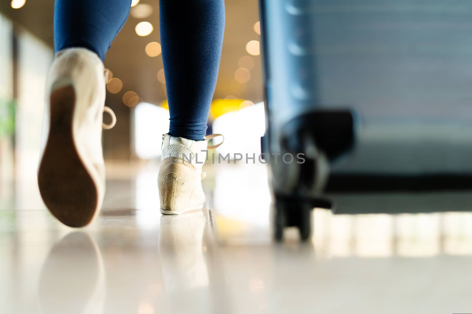 traveler with suitcase walking with carrying luggage and passenger for tour in the airport terminal for air traveling