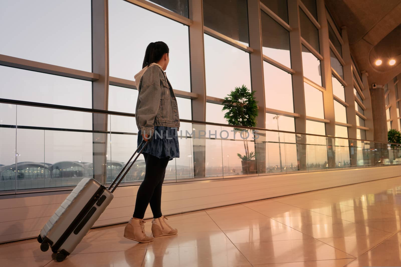 traveler with suitcase walking with carrying luggage and passenger for tour in the airport terminal for air traveling