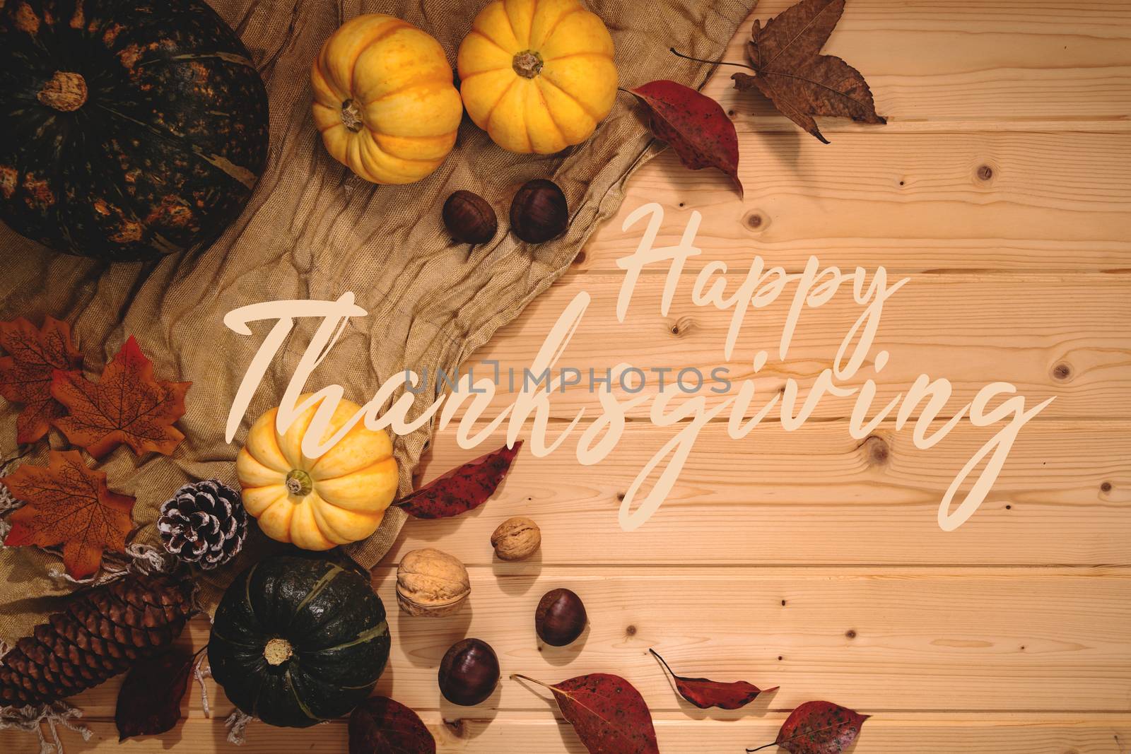 Happy Thanksgiving Day with pumpkin and nut on wooden background