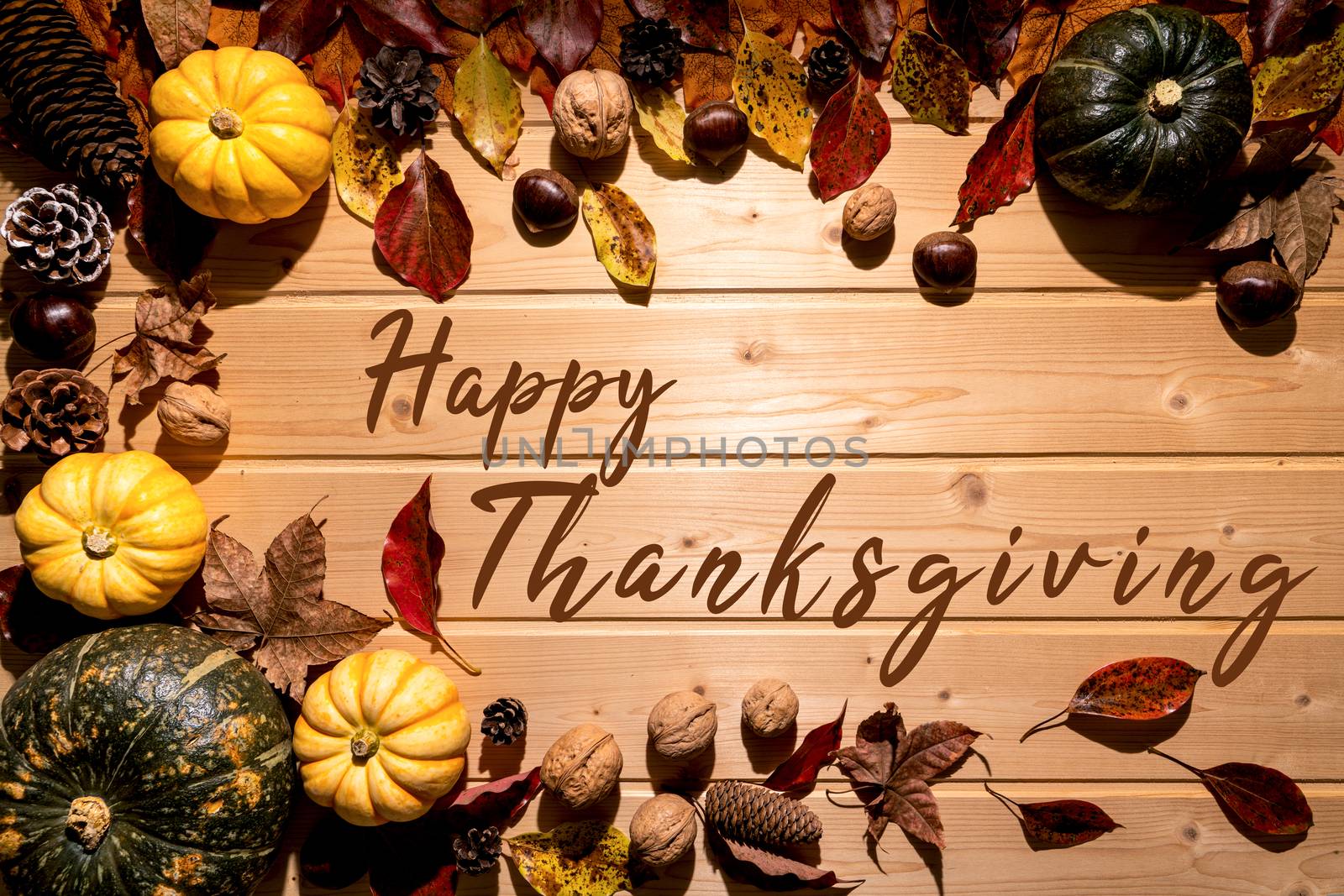 Happy Thanksgiving Day with pumpkin and nut on wooden background
