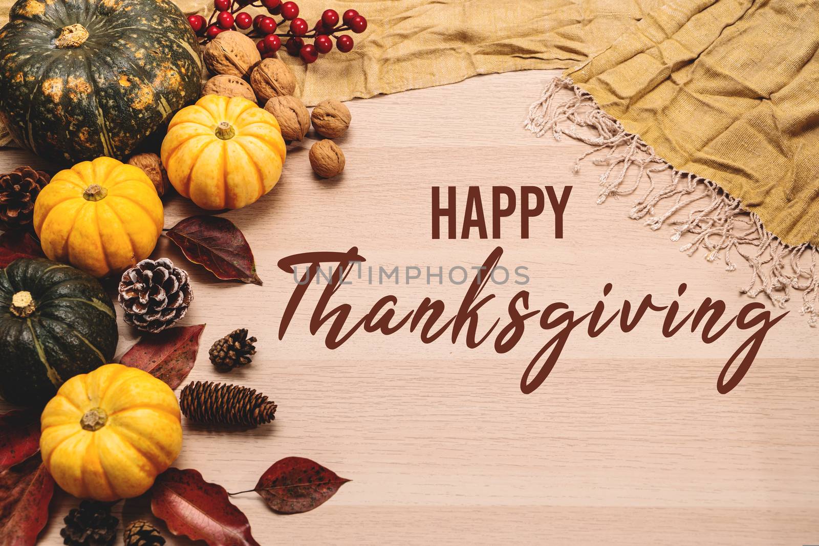 Happy Thanksgiving Day with pumpkin and nut on wooden background