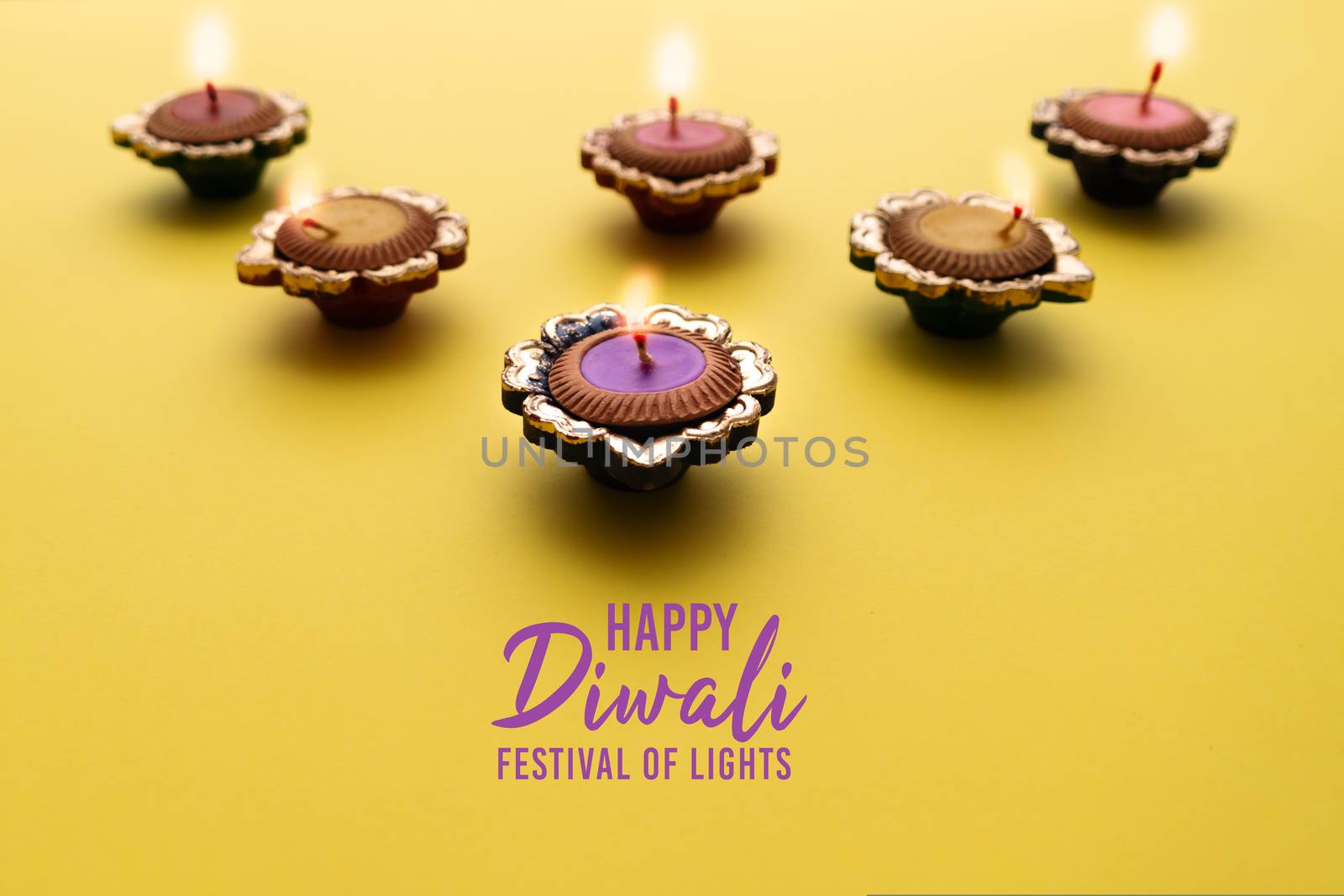 Happy Diwali - Clay Diya lamps lit during Dipavali, Hindu festival of lights celebration. Colorful traditional oil lamp diya
