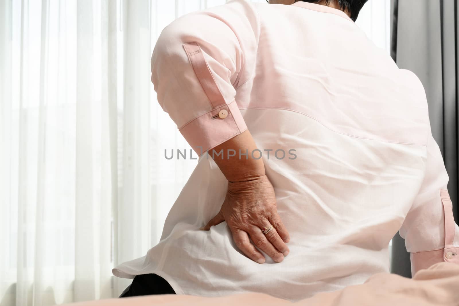 Old woman back pain at home, health problem concept