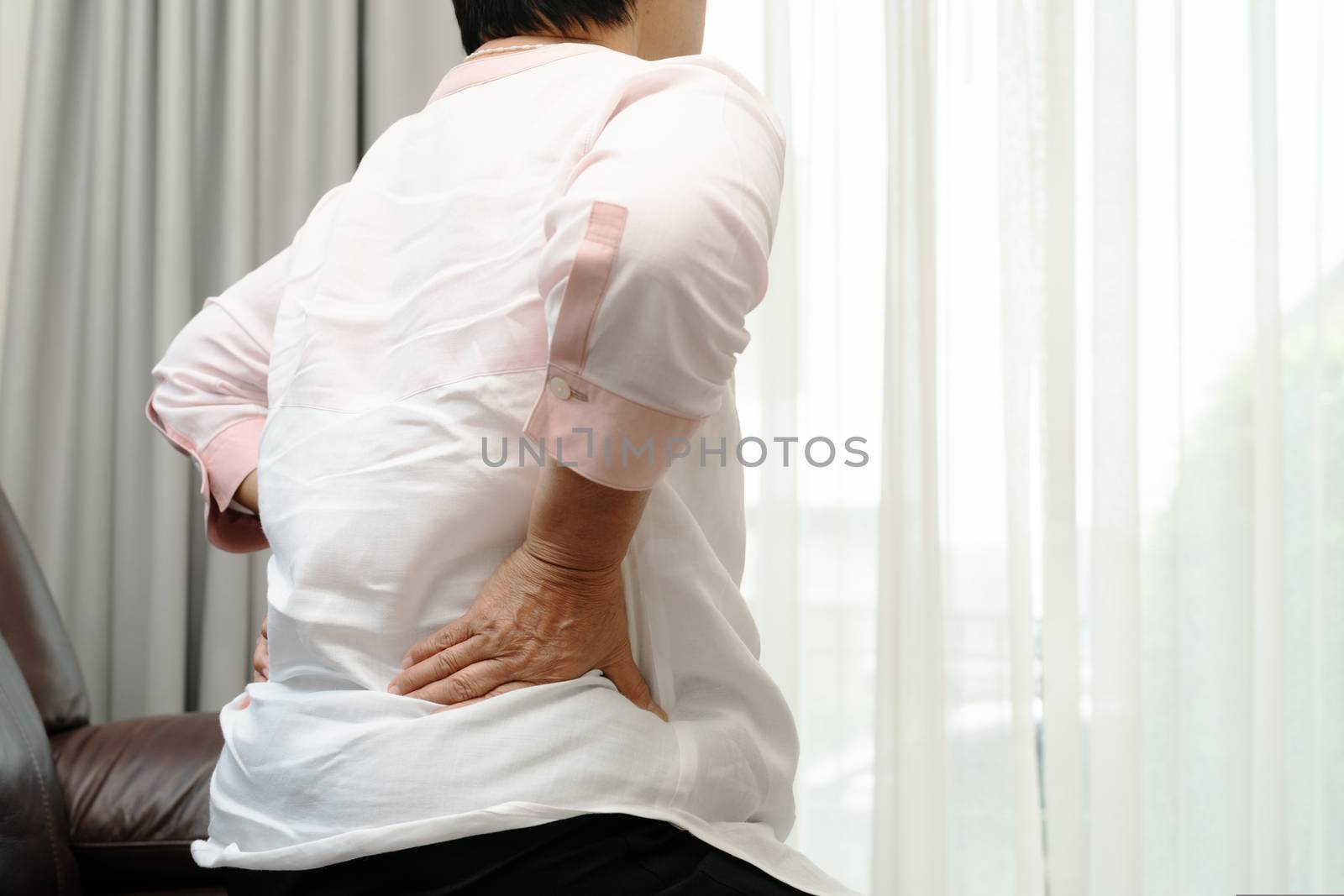 Old woman back pain at home, health problem concept
