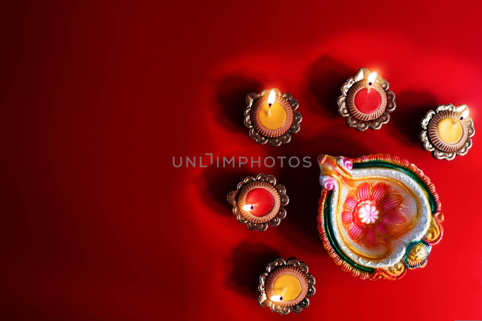 Happy Diwali - Clay Diya lamps lit during Dipavali, Hindu festival of lights celebration. Colorful traditional oil lamp diya