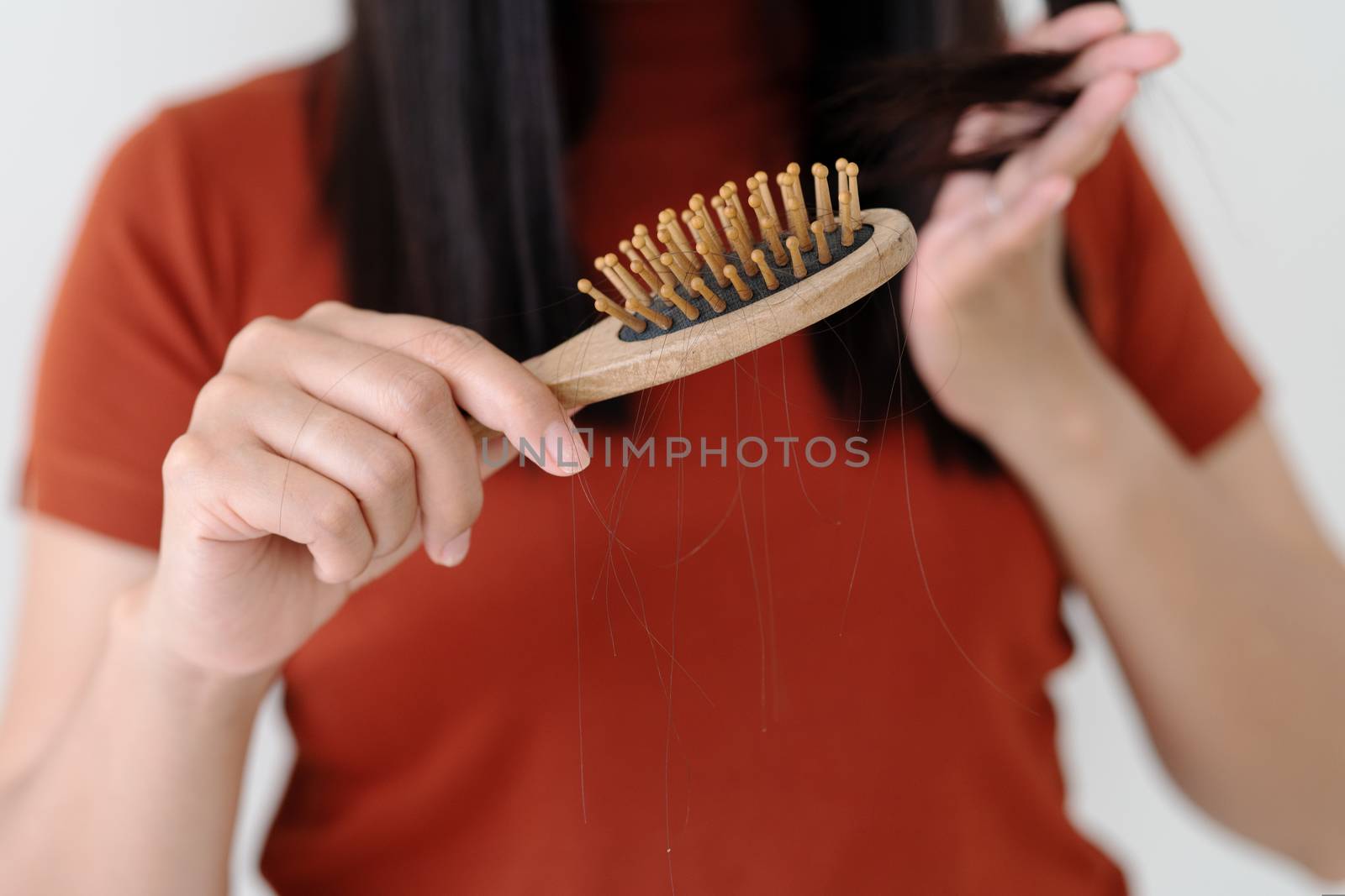 long loss hair on woman brush with and woman looking at her hair