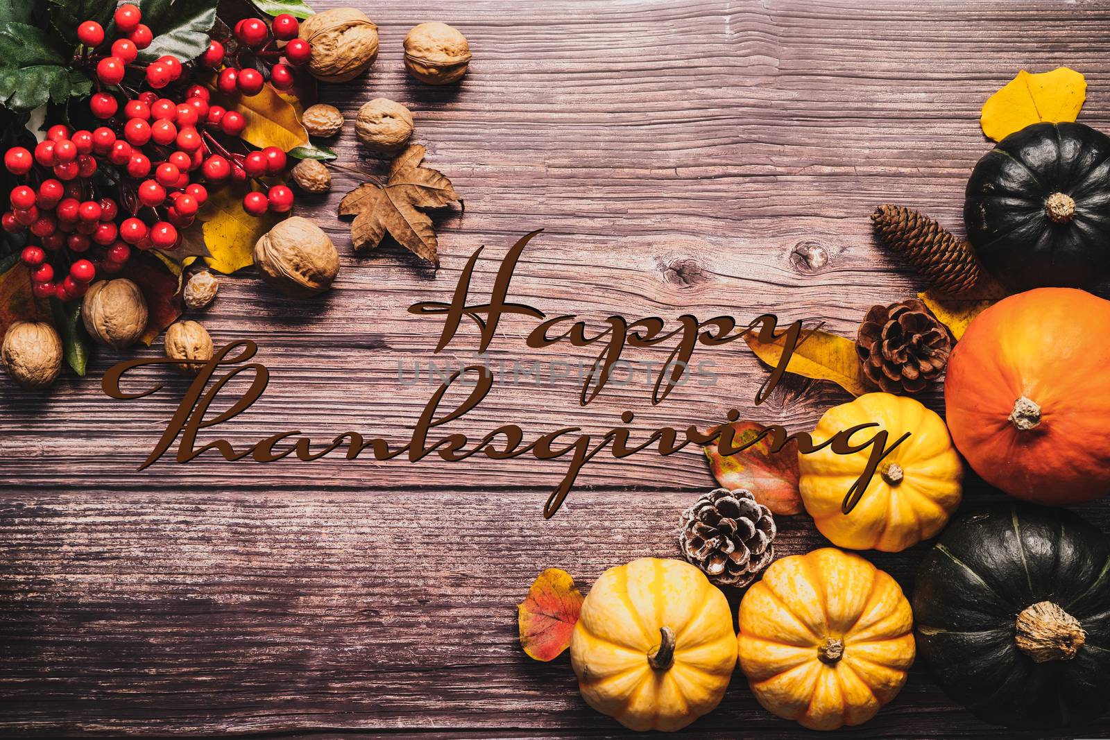 Happy Thanksgiving Day with pumpkin and nut on wooden table