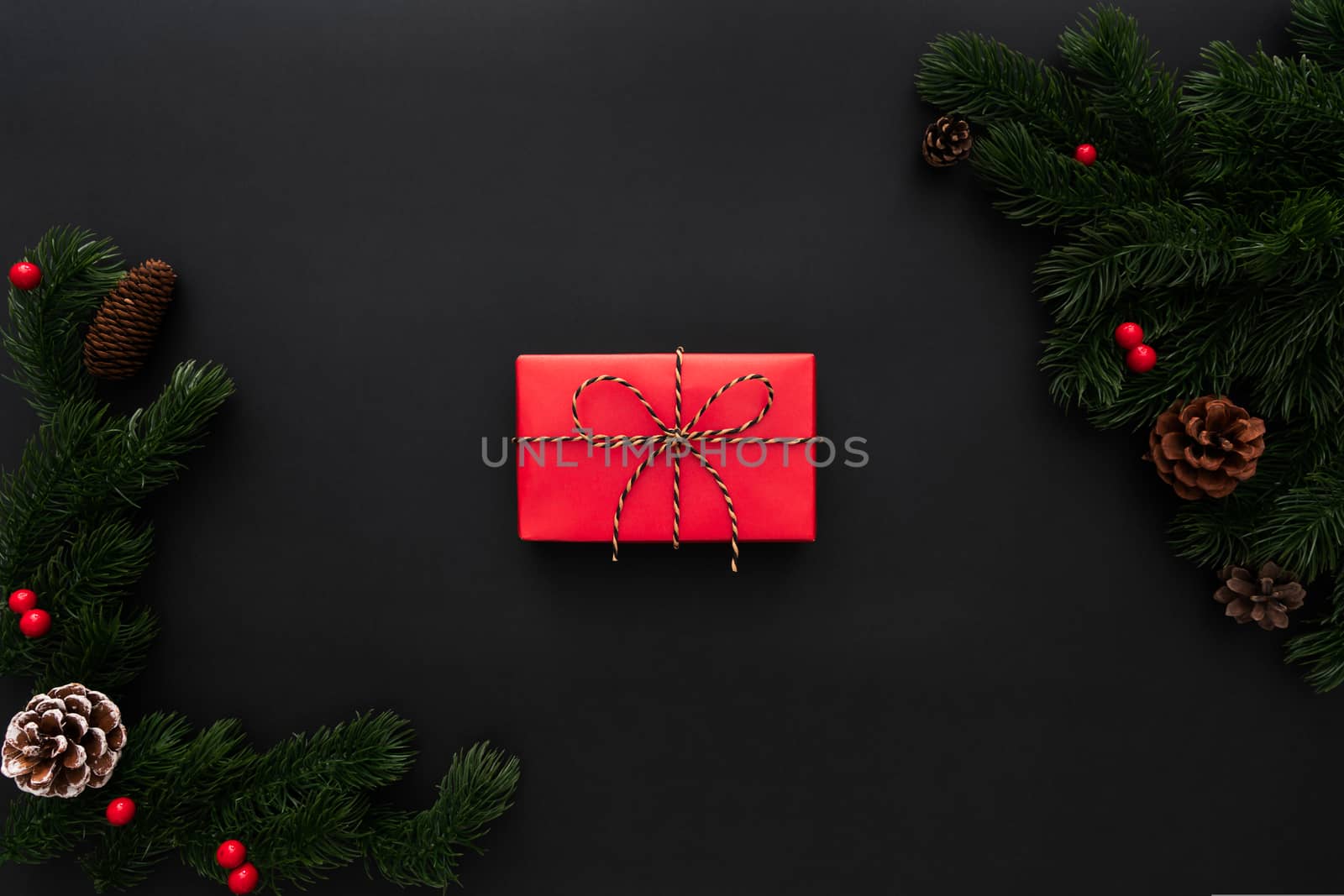 Christmas gift box and pine tree with xmas decoration on black background