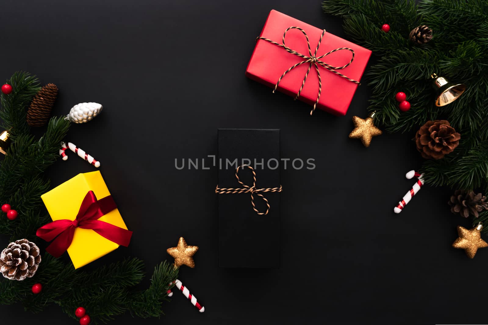 Christmas gift box and pine tree with xmas decoration on black background