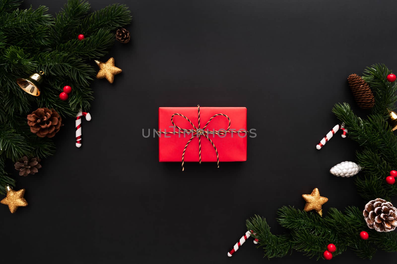 Christmas gift box and pine tree with xmas decoration on black background
