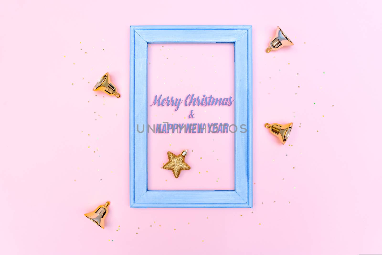 Christmas bell and star with photo frame on pink background