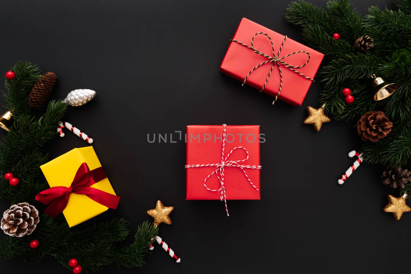 Christmas gift box and pine tree with xmas decoration on black background