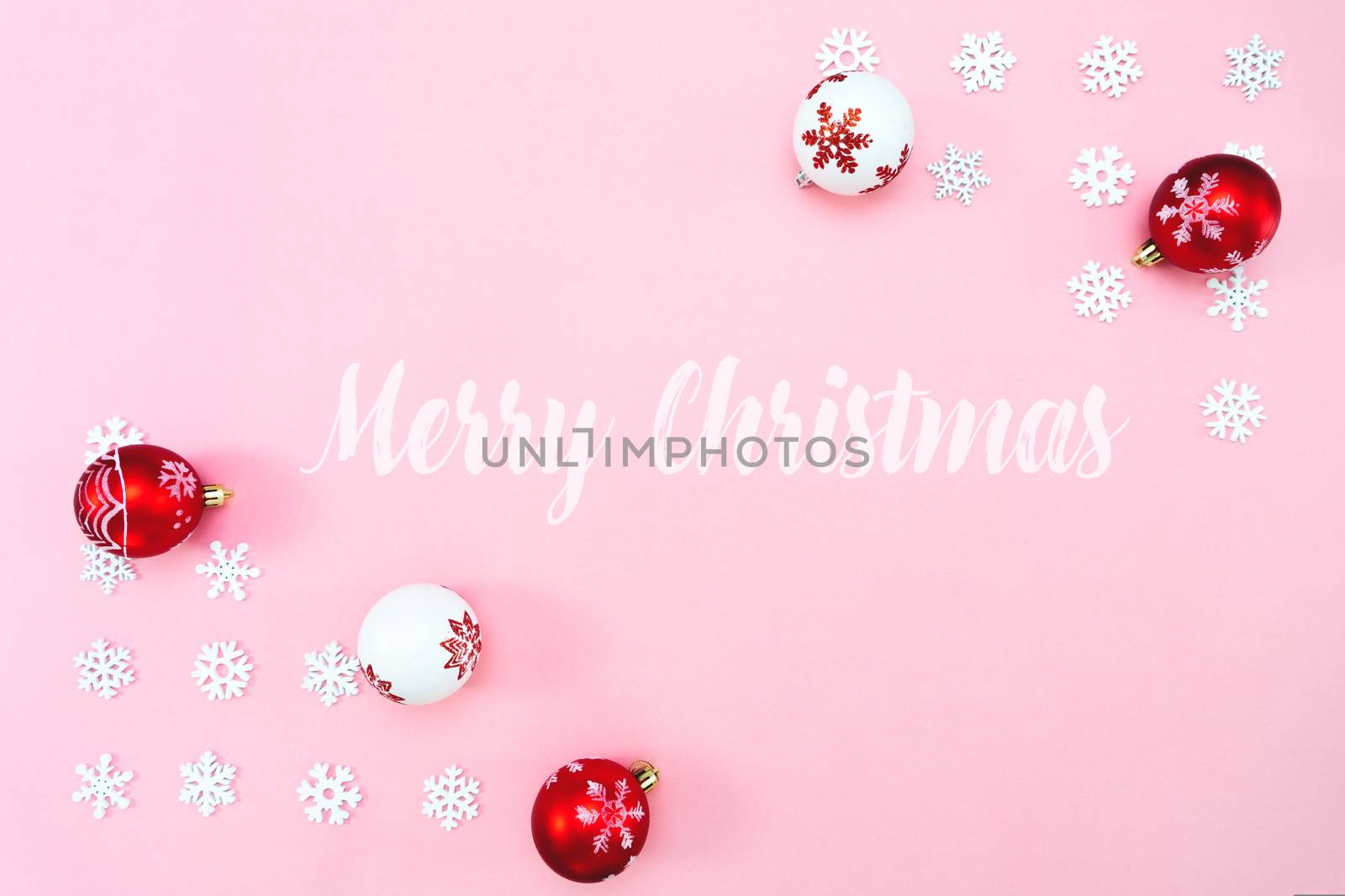 Christmas composition. Christmas balls and snowflakes decorations on pink background. Flat lay, top view, copy space