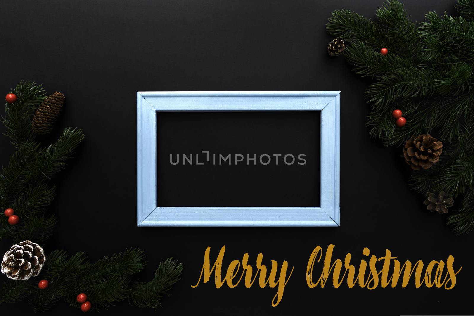 Christmas pine tree and photo frame with xmas decoration on black background