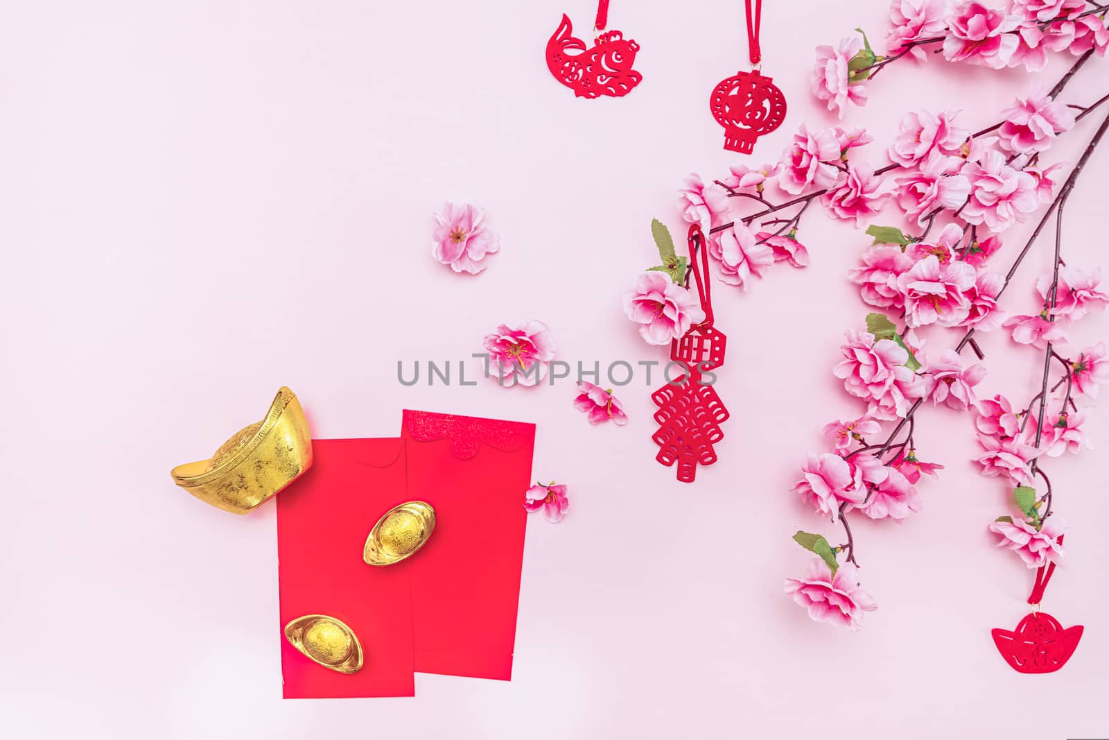 Flat lay Chinese lunar new year offering red envelope on pink background, Translation of text appear in image: Prosperity, rich and healthy.