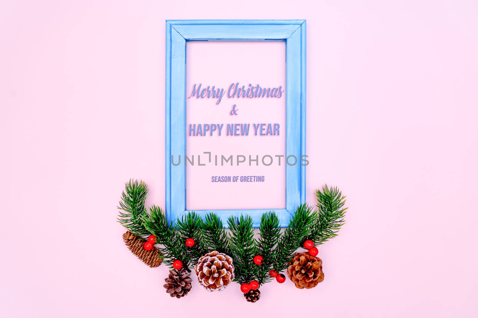 Christmas pine tree and photo frame with xmas decoration on pink background