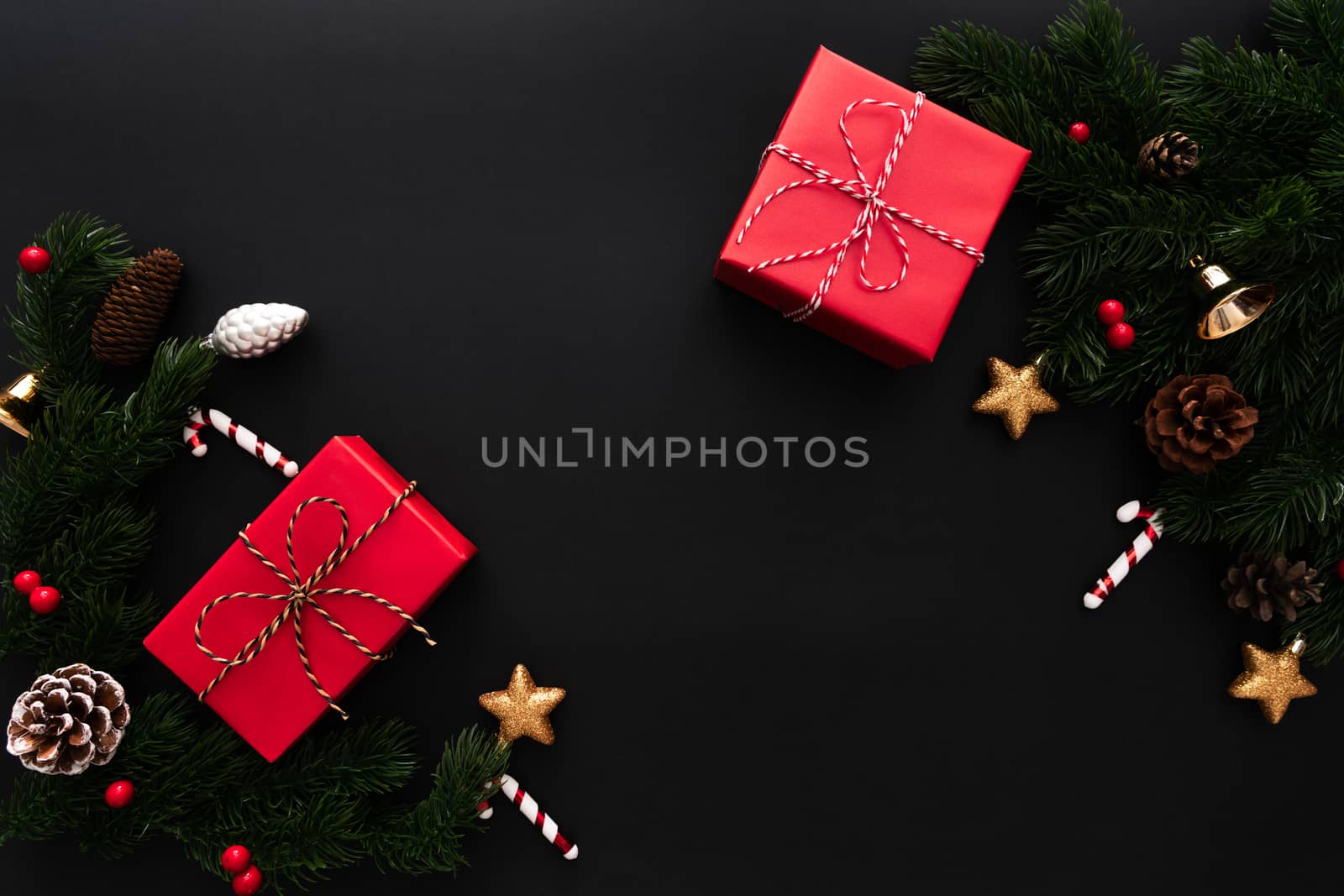 Christmas gift box and pine tree with xmas decoration on black background