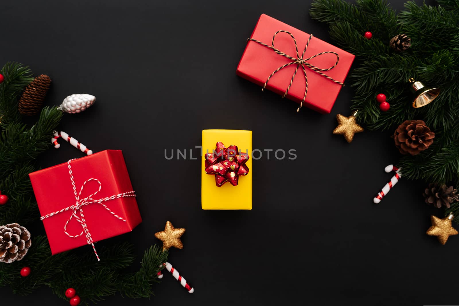 Christmas gift box and pine tree with xmas decoration on black background