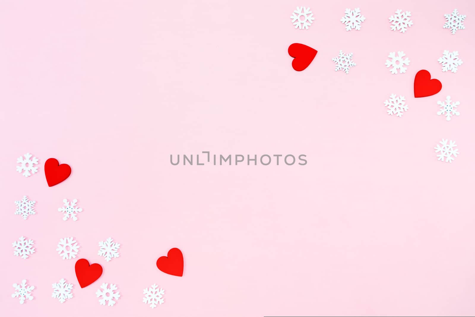 Valentine's Day background. red hearts and snowflakes on pink background. Valentines day concept. Flat lay, top view, copy space