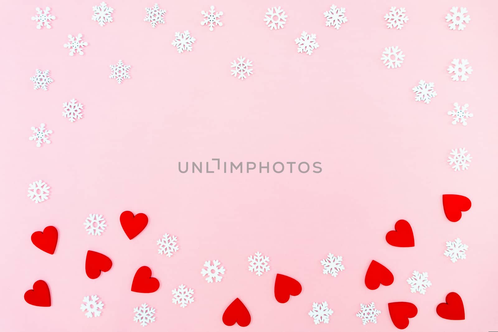 Valentine's Day background. red hearts and snowflakes on pink background. Valentines day concept. Flat lay, top view, copy space