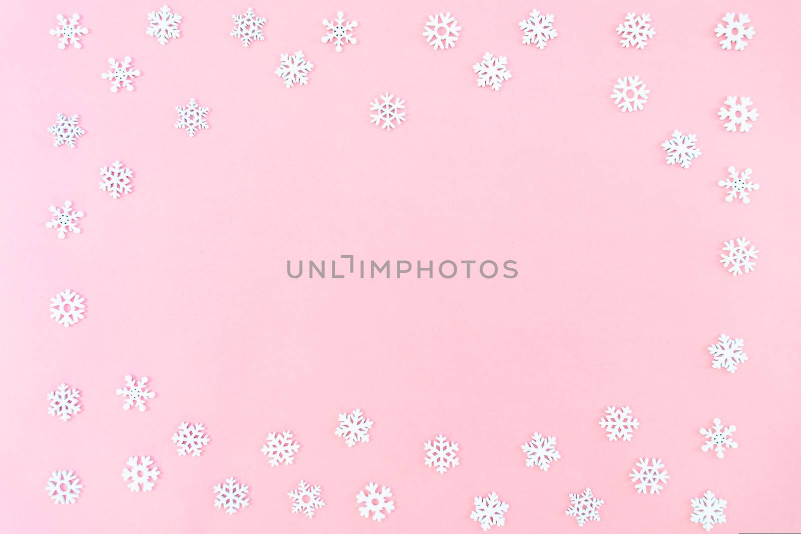 Christmas composition. Christmas snowflakes on pink background. Flat lay, top view, copy space