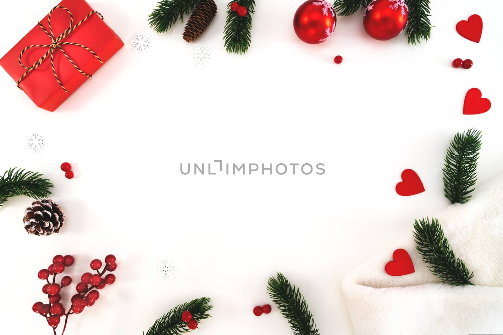 Christmas composition. Christmas gift, fir blanket, pine cones, fir branches on white background. Flat lay, top view, copy space