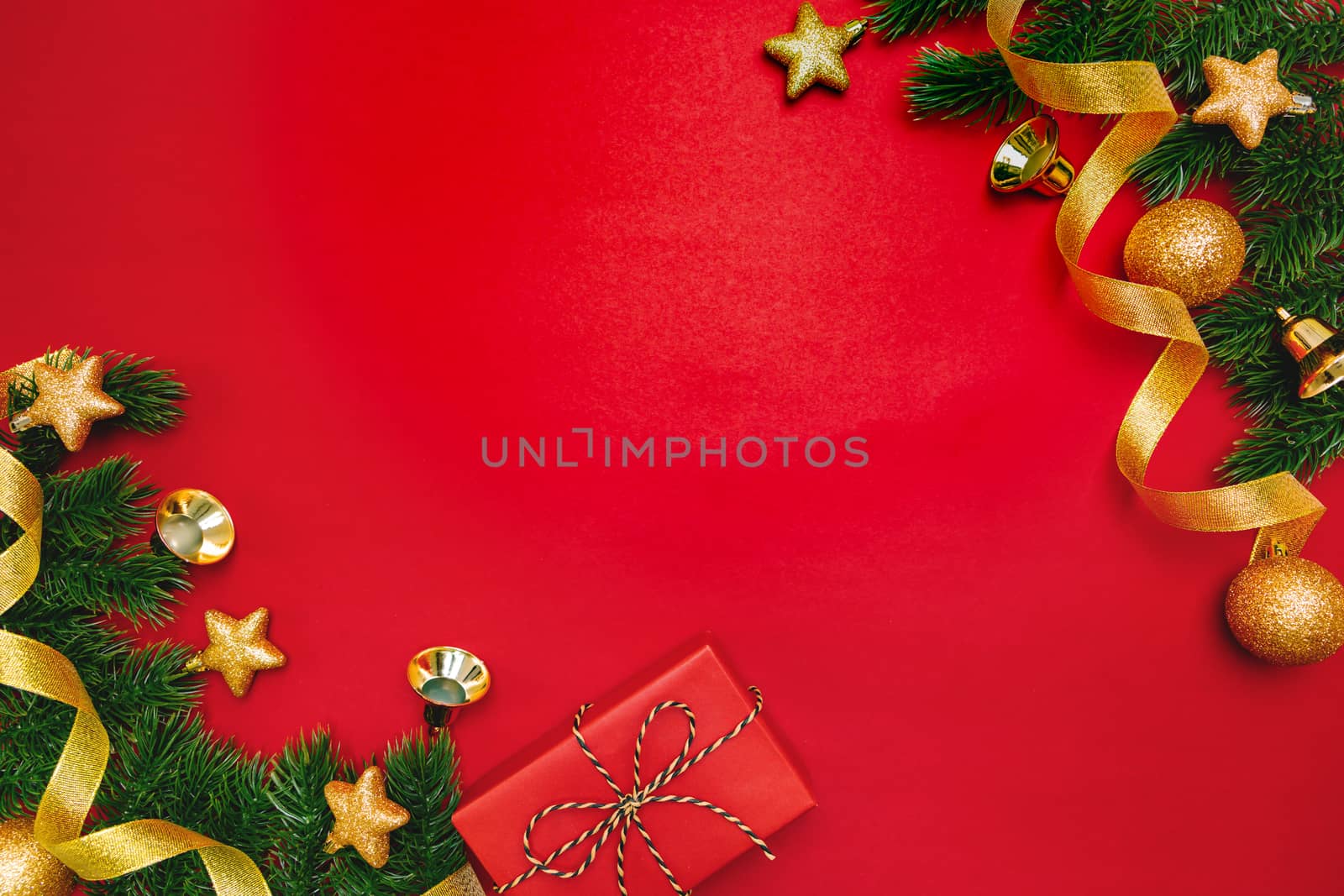 Christmas present and pine tree with xmas decoration on Red background