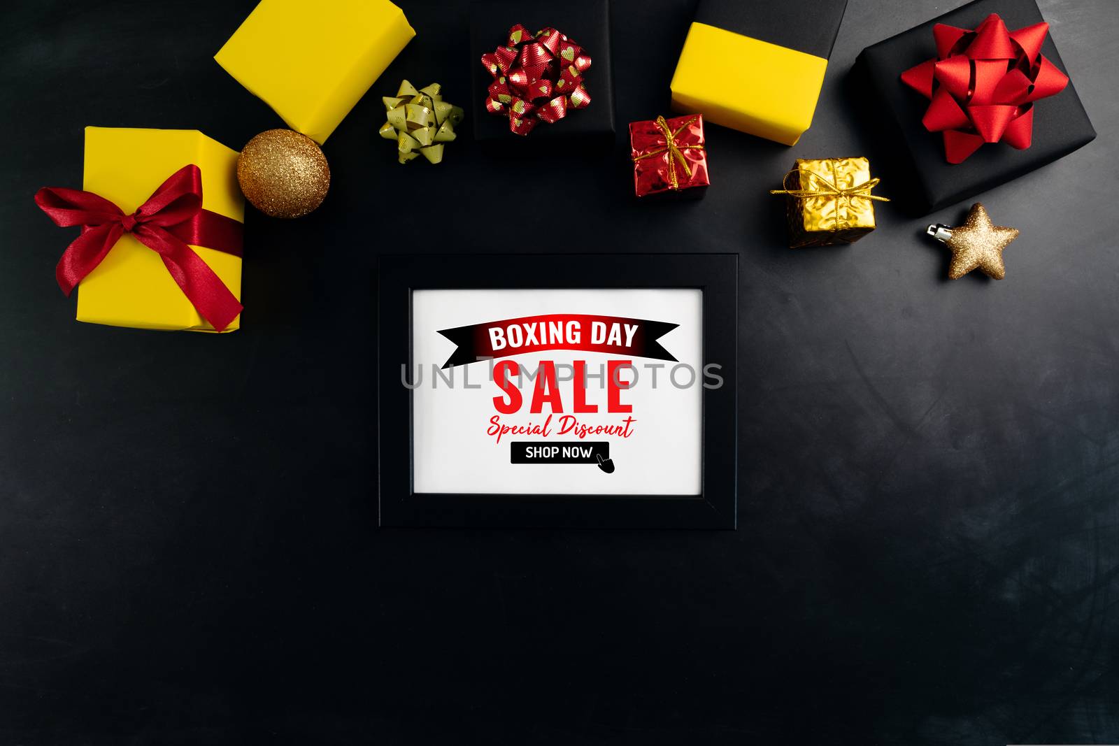 Boxing day sale with Christmas present and xmas decoration on black background