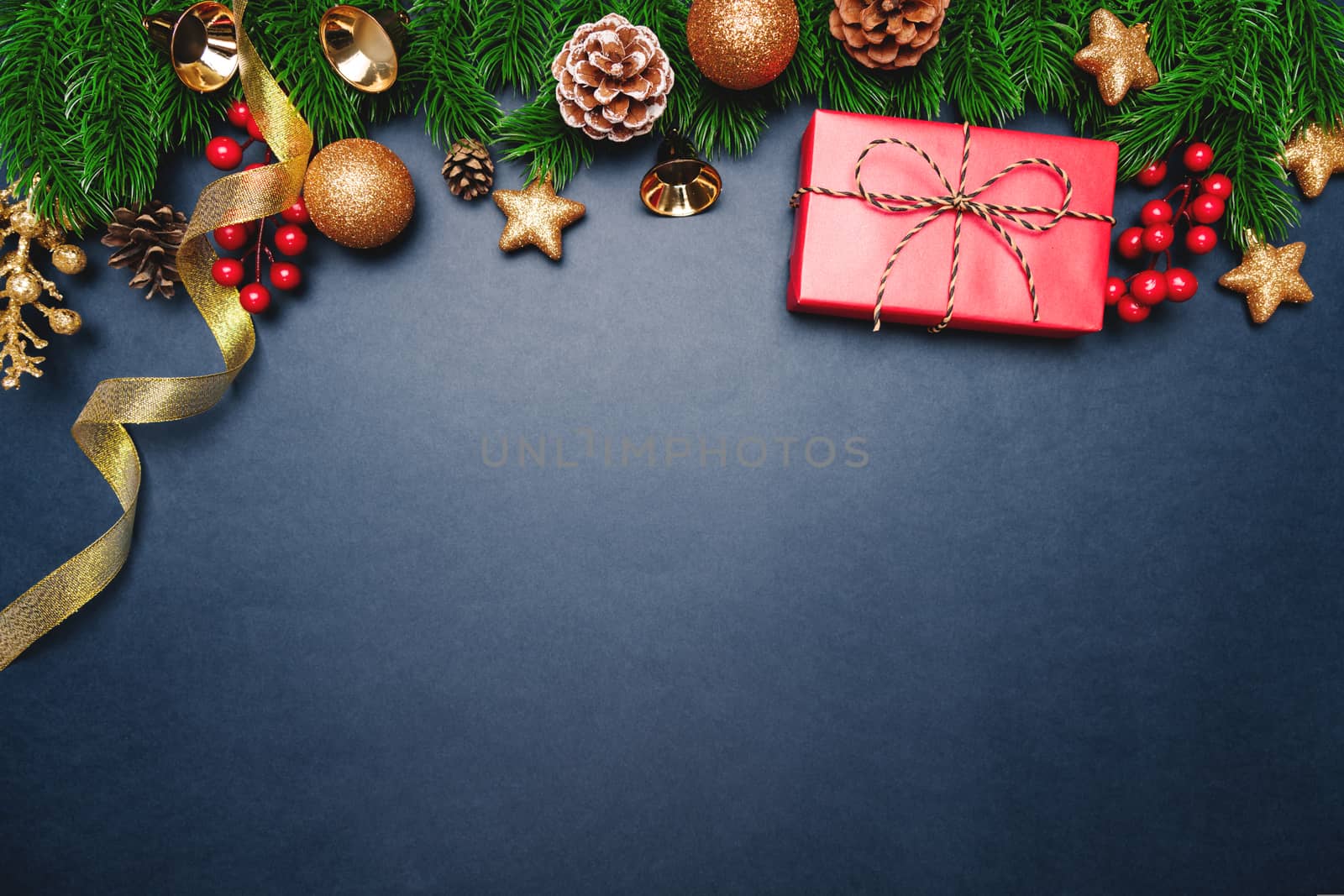 Christmas present and pine tree with xmas decoration on blue background