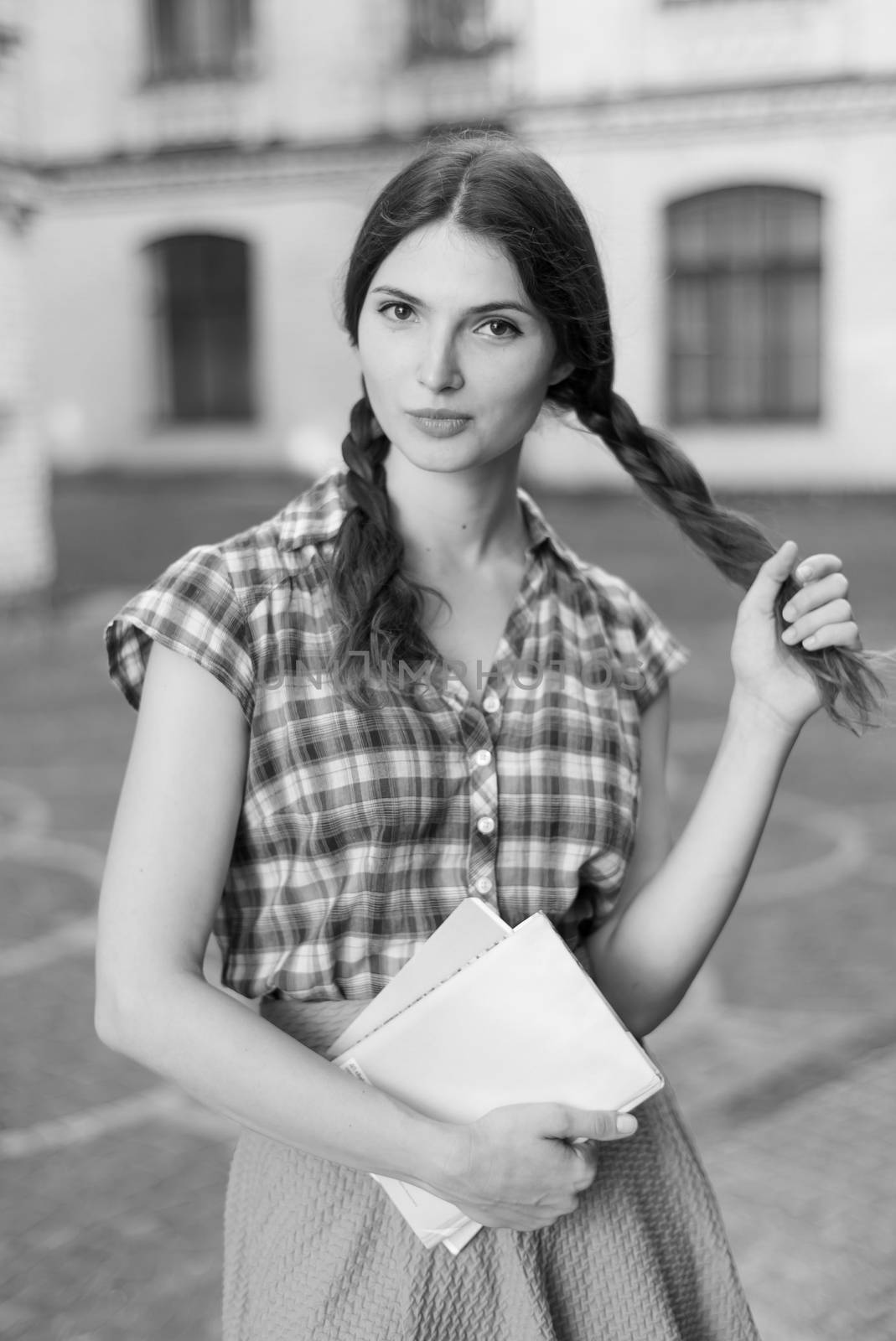 Girl student in skirt and plaid shirt. Kyiv. Ukraine