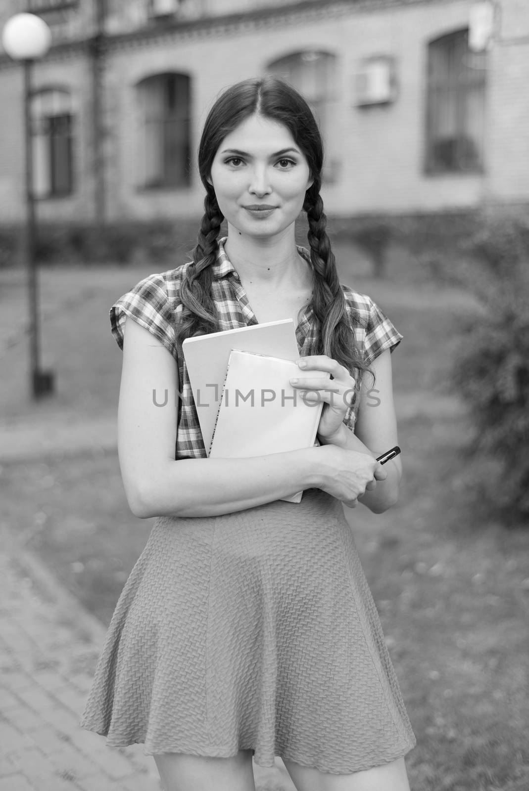 Girl student in skirt and plaid shirt. Black and white photo. BW by Mykola_Kondrashev