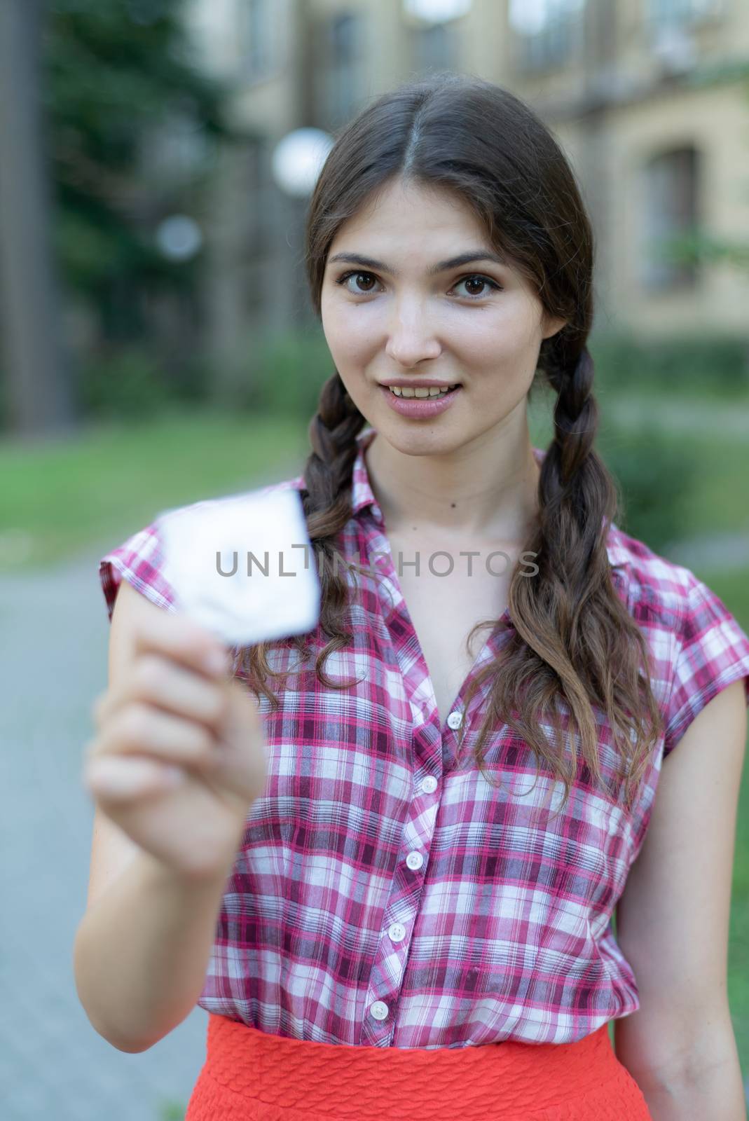 Young girl holding a condom. Protected sex