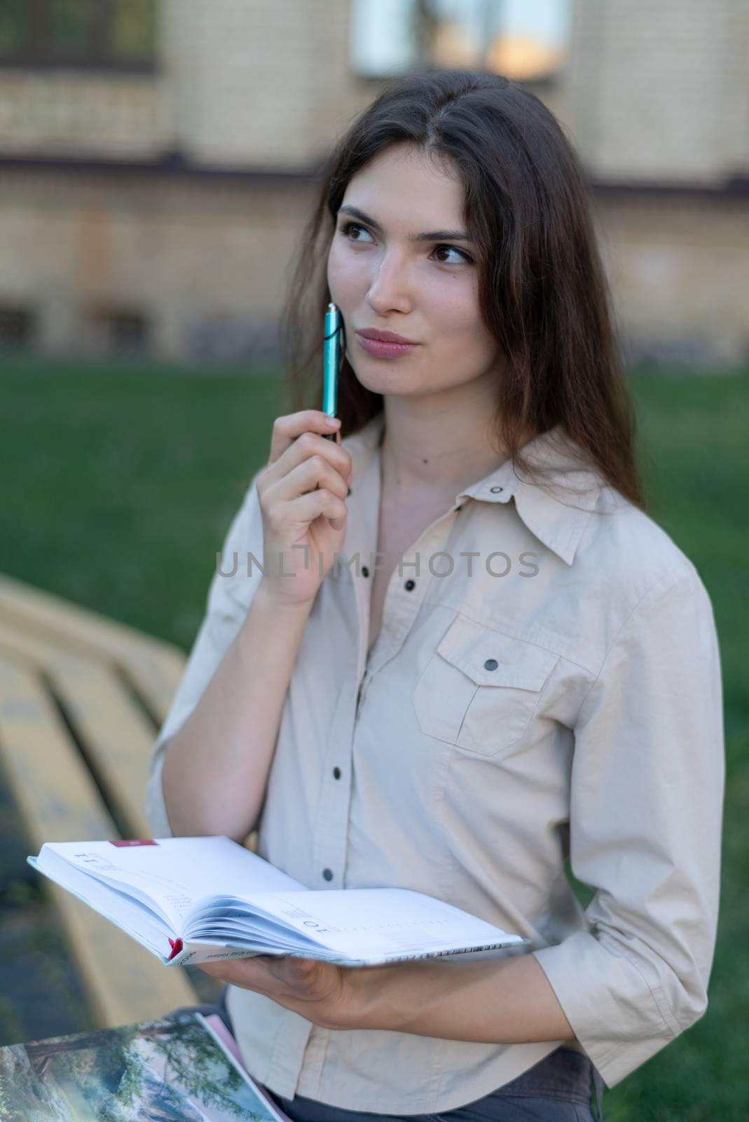 Young girl student with pen.