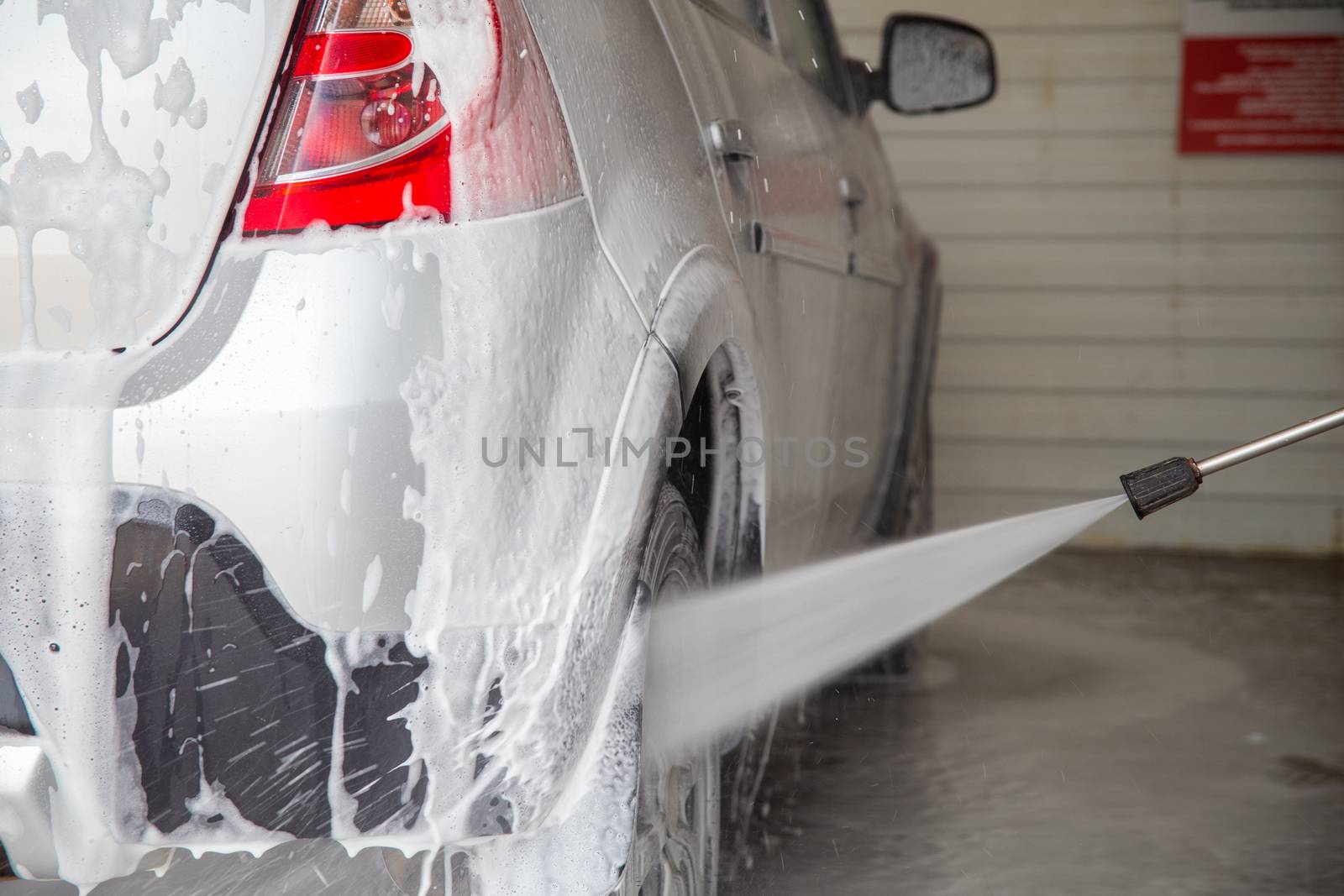 a closeup view of process of indoor wet car washing.