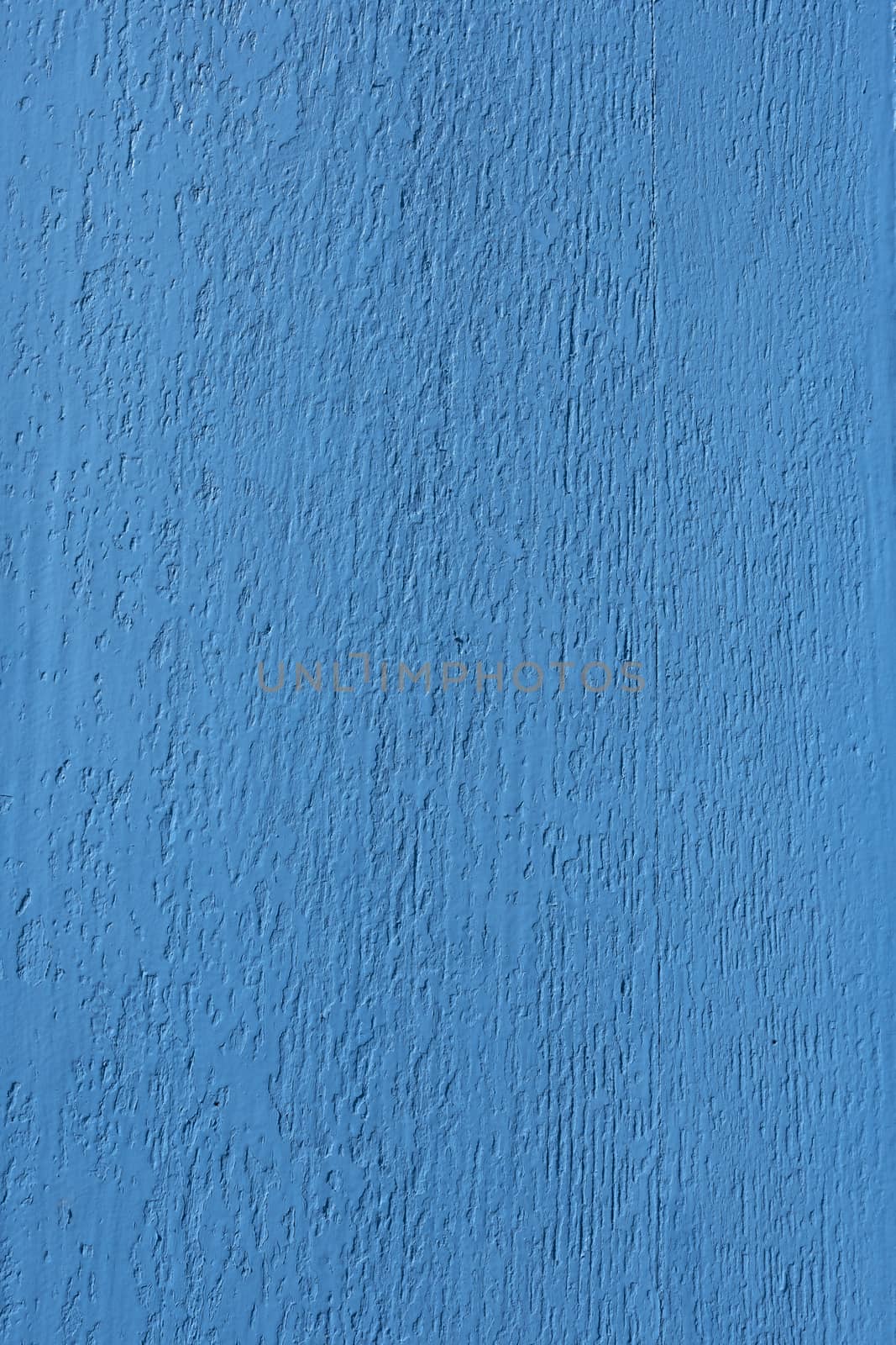 closeup of old wood with bright fresh blue paint
