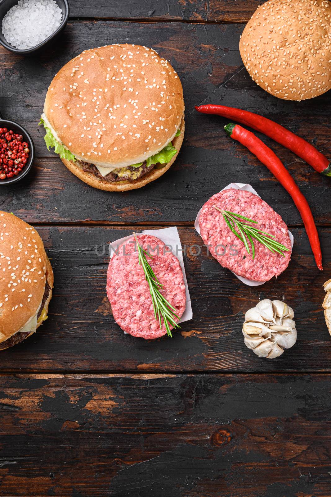 Homemade hamburger with ingredients on dark wooden background, topview by Ilianesolenyi