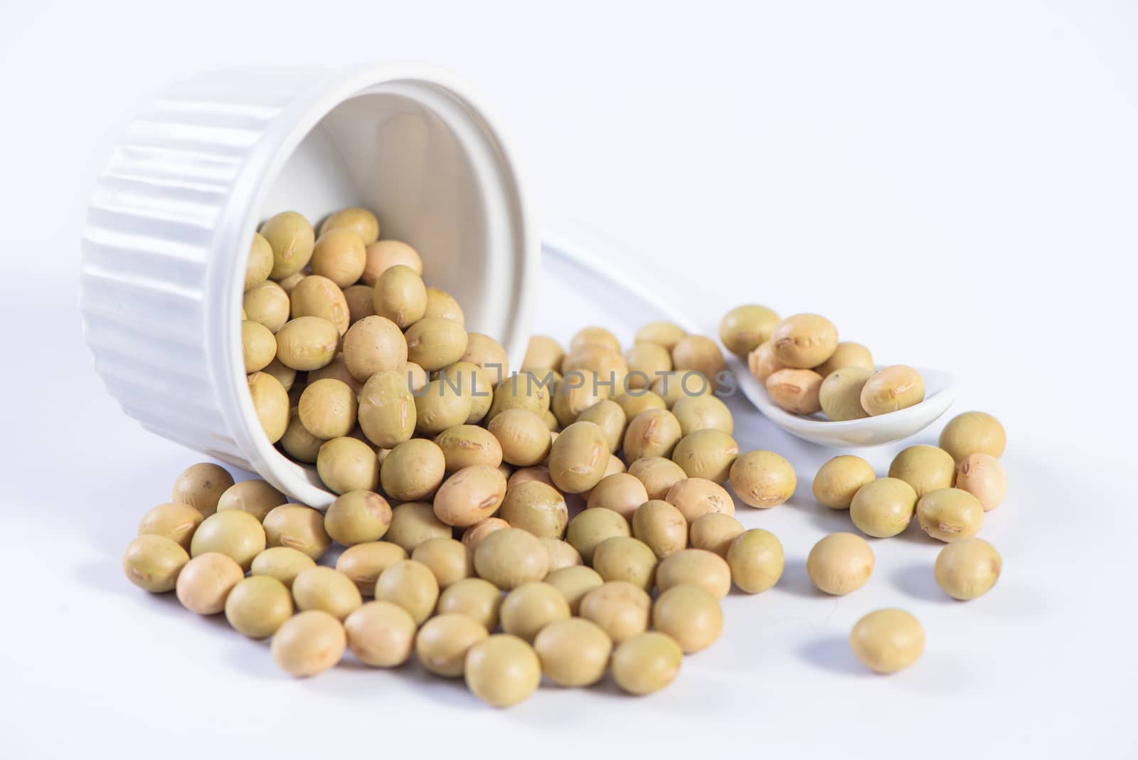 Yellow-green Taiwanese organic non-GMO soybeans, soy beans in a container isolated on white backgorund, close up, clipping path.