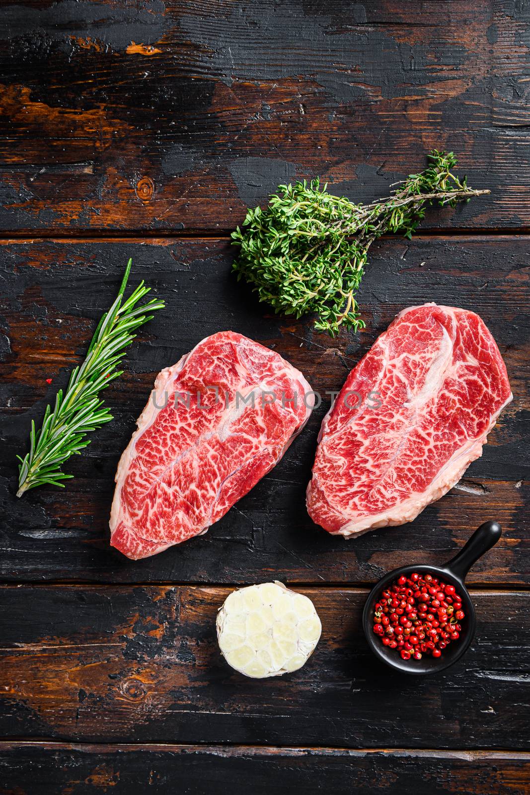 Top blade steak, bio raw meat, marbled beef . old wood table background. Top view by Ilianesolenyi