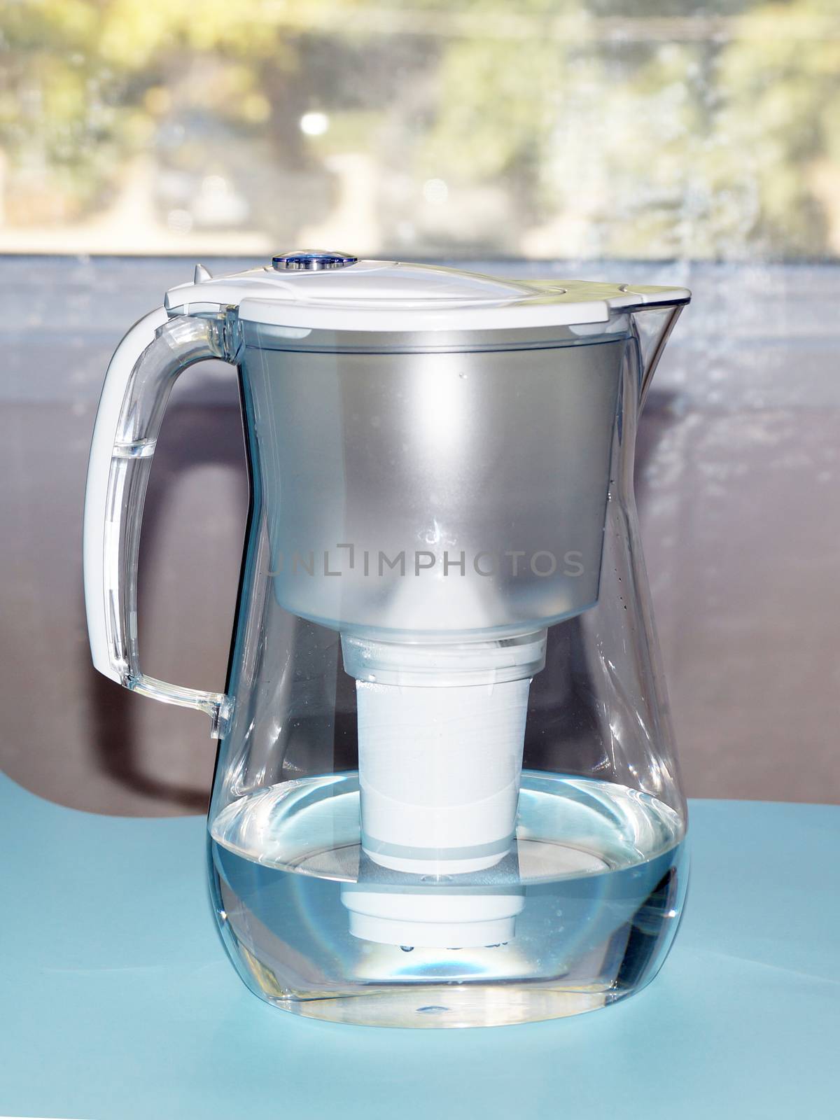 a jug for filtering water against the background of the window