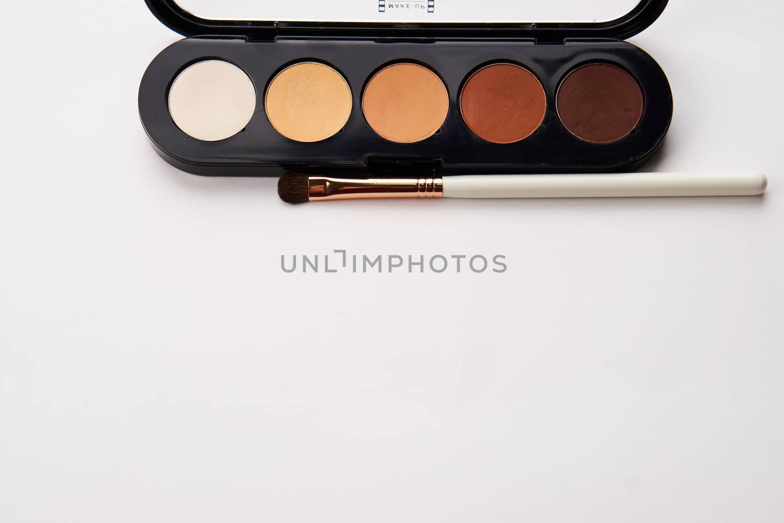 eyeshadows on isolated background and makeup brushes professional cosmetics by SHOTPRIME