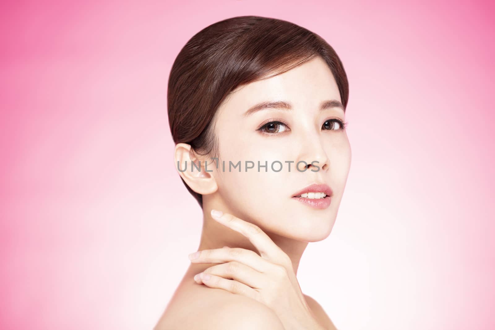 Close up of beautiful young woman's face with clean perfect skin by tomwang